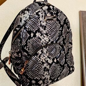 Mid-size also faux snake skin backpack